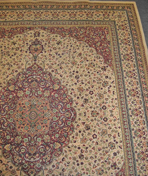 A Wilton Tabriz style carpet, the ivory quartered field centred with a lobed floral motif , multi