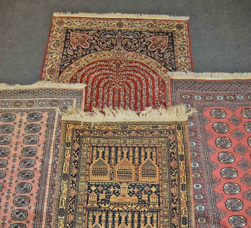 A Persian prayer rug, the floral field decorated with an urn, multi boardered and fringed 190cm x