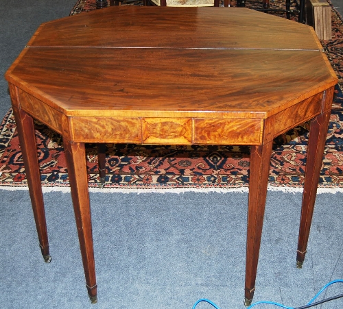 A late George III mahogany octagonal folding tea table, satinwood crossbanded, the frieze