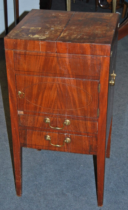 A George III mahogany night table, the split hinged top enlcosing a fitted interior above cupboard