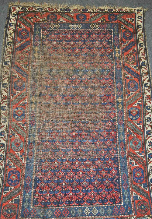 A Caucasian red and blue ground rug with geometric floral stylised field, multi boardered and