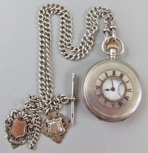 A silver cased Swiss hunter pocket watch hallmarked Birmingham 1924, the case with black enamel