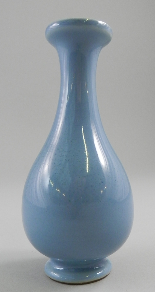 A Chinese pale blue bottle vase, raised top leading to flaring neck, ovoid vessel and circular foot,