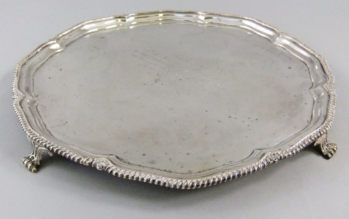 A silver salver Sheffield 1916 with pie crust edge raised on 4 paw feet, engraved `Presented to Miss