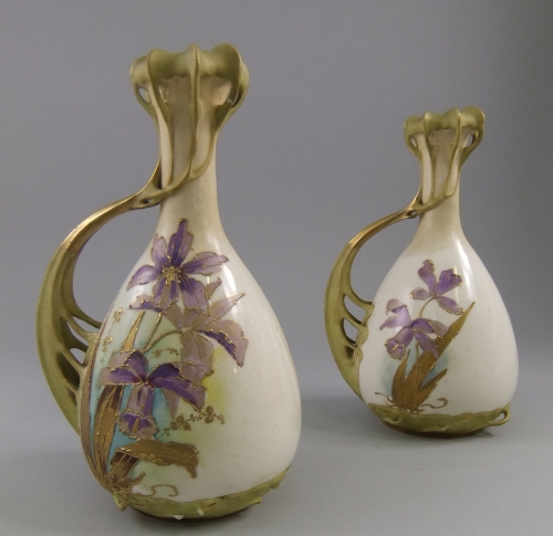 A pair of reticulated Austrian bottle vases, early 20th century, with pierced foliate style handle