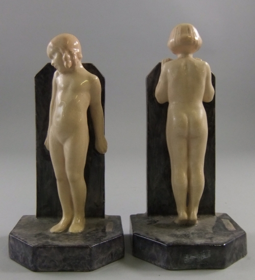 A pair of Art Deco style figural bookends, 20th century, the bookends supported by female nude