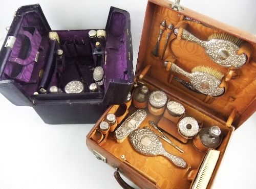 A late 19th century Gladstone style travel case in purple leather, partially fitted with bottles,