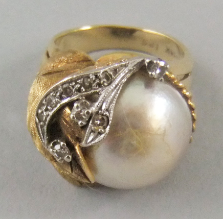 A 14ct gold mabe pearl and diamond set cocktail ring with asymmetrical leaves design. approx UK size