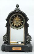 A Victorian bronze mounted black slate mantel clock The pineapple finial mounted domed top above the