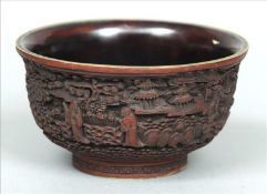 A well carved Chinese cinnabar lacquer bowl Decorated with figures amongst buildings, with a plain