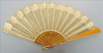 A late 19th/early 20th century gilt metal sequin mounted fan 19 cms high. Overall good, some general