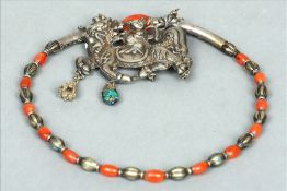 A finely worked 19th century Chinese silver, carnelian and turquoise necklace Formed as a figure