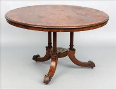 A Victorian burr walnut tilt-top breakfast table The figured circular top supported on three