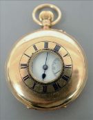 A 9 ct gold cased half hunter pocket watch The outer case with blue enamelled Roman numerals