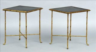 A pair of leather topped brass side tables The legs and bandings of faux bamboo form. Each 40 cms