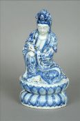 A Chinese blue and white porcelain model of Guanyin Typically modelled seated on a lappet cast