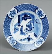 A 19th century Chinese blue and white plate The broad rim decorated with foliate vignettes, the