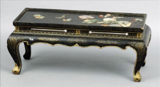 A Chinese hardstone inset lacquered coffee table The rectangular top decorated with various