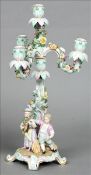 A Continental porcelain three branch candelabrum Of scrolling floral form, standing on a domed