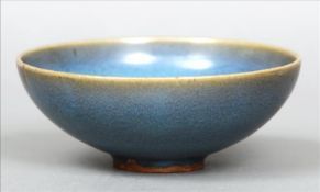 A Chinese porcelain Sung type bowl With a bluish purple glaze. 18 cms diameter. Firing cracks to top
