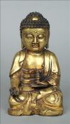 A Sino-Tibetan gilt bronze model of Buddha Typically modelled. 21 cms high. Some general wear.