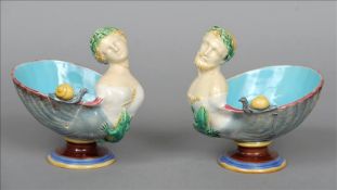 A pair of 19th century Minton majolica figural comports Each of shell form, one with a male bust,