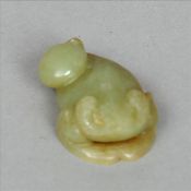 A Chinese carved green and russet jade pebble Modelled as a three legged toad. 6 cms long. Generally