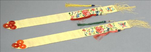 A pair of Chinese orange jade mounted needlework bookmarks 47 cms long. (2) Generally in good