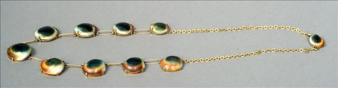 An unusual gold plate mounted necklace formed from cowrie shells Each separated by an oval link.