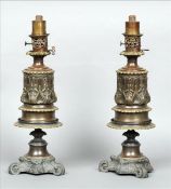A pair of 19th century Continental bronze and cast white metal oil lamps Each decorated with Art