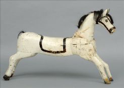 A late 19th century carousel horse The carved and painted model with a removable head. 110 cms long.