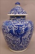 A 19th century Chinese blue and white porcelain vase and cover Decorated overall with phoenix within