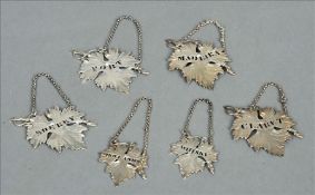 A set of four George IV Scottish silver vine leaf decanter labels, each hallmarked Edinburgh 1825,