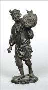 A late 19th century Japanese bronze figure Formed as a fisherman carrying his catch, the base with