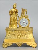A 19th century ormolu mantle clock Surmounted with a young lady playing a pianola, the silvered