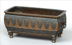 A 19th century Chinese bronze planter Of rectangular form with bands of floral and lappet cast