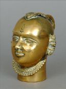 A 19th century Indian bronze deities head Formed with curled plaited hair and wearing jewellery.