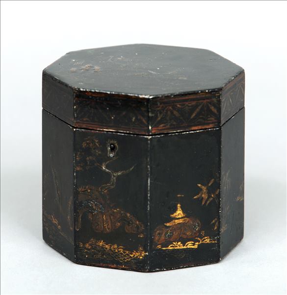 A Regency black lacquered tea caddy Of octagonal section, the hinged cover enclosing a single lidded