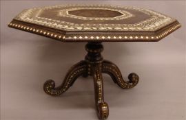 A late 19th century Anglo-Indian ivory inlaid coffee table The octagonal top with bands of scrolling