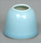 A Chinese porcelain ink pot The pale blue ground vessel of beehive shape, the underside with blue
