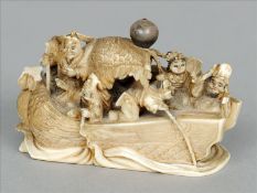 A late 19th/early 20th century carved ivory netsuke Formed as various figures aboard a boat,