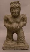 A carved stone figure by repute Chinese Ming, possibly a Lohan Modelled with furrowed brow and