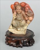A Chinese carved soapstone bolder Modelled as a sage and young boy opposing archaistic script and