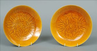 A pair of Chinese Liao Dynasty (907-1125) porcelain plates Yellow glazed with incised foliate