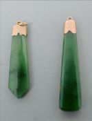 A 9 ct gold mounted jade pendant Together with another similar unmarked gold mounted jade pendant.