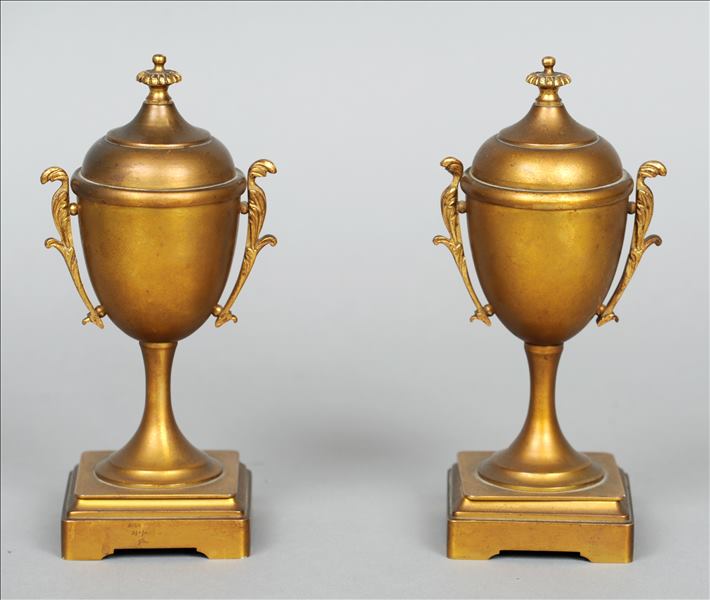 A pair of 19th century gilt bronze urn form garnitures Each gadrooned finial above a plain bulbous