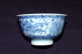 A Chinese blue and white porcelain tea bowl Decorated with a pair of phoenix within lotus strapwork,