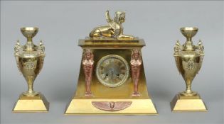 A 19th century brass and copper mantle clock garniture The architecturally formed clock surmounted