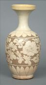 A Cizhou type stoneware vase Carved through a cream white slip onto a chocolate brown under slip,