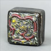 A Chinese silver and enamel box The hinged domed lid decorated with a dragon chasing a flaming pearl